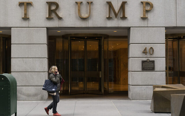 A woman walks past the Trump Building in New York's financial district, Wednesday, Jan. 13, 2021. Mazars USA LLP, the accounting firm that prepared former President Donald Trump’s annual financial statements, says the documents “should no longer be relied upon” after investigators said they found evidence he and his company regularly misstated the value of assets. (AP Photo/Mark Lennihan, File)