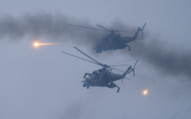 Military helicopters fly over the Osipovichi training ground during the Union Courage-2022 Russia-Belarus military drills near Osipovichi, Belarus, on February 17, 2022. (AP Photo/Alexander Zemlianichenko Jr.)