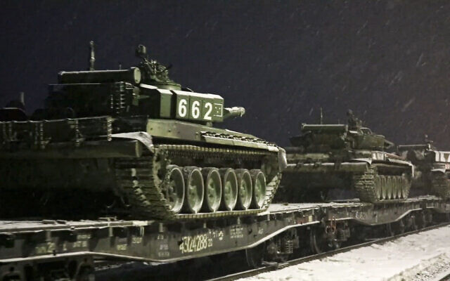 In this photo taken from video provided by the Russian Defense Ministry Press Service on February 18, 2022, Russian army tanks are loaded onto railway platforms to move back to their permanent base after drills in Russia. (Russian Defense Ministry Press Service via AP)