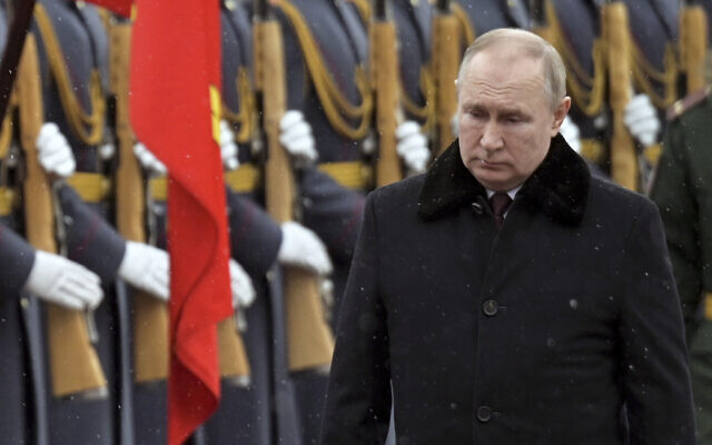 Russian President Vladimir Putin attends a wreath-laying ceremony at the Tomb of the Unknown Soldier, near the Kremlin Wall during the national celebrations of the 'Defender of the Fatherland Day' in Moscow, Russia, on February 23, 2022. (Alexei Nikolsky, Kremlin Pool Photo via AP)