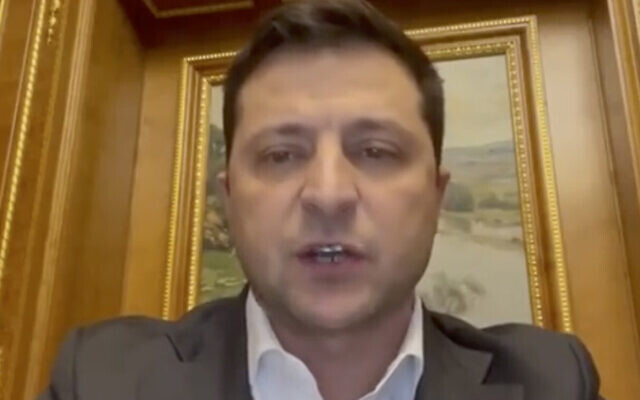 In this handout photo taken from video provided by the Ukrainian Presidential Press Office, Ukrainian President Volodymyr Zelensky addresses the nation in Kyiv, Ukraine, Thursday, Feb. 24, 2022. Zelensky declared martial law, saying Russia has targeted Ukraine's military infrastructure. He urged Ukrainians to stay home and not to panic. (Ukrainian Presidential Press Office via AP)