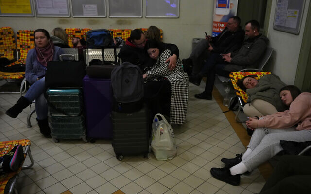 People from neighboring Ukraine rest at a train station that was turned into an accommodation center in Przemysl, Poland, on February 24, 2022. (AP Photo/Petr David Josek)