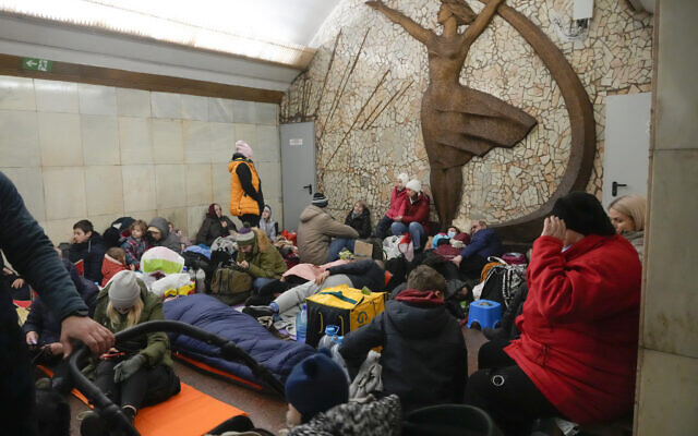 People gather in the Kyiv subway, using it as a bomb shelter in Kyiv, Ukraine, February 25, 2022. (AP Photo/Efrem Lukatsky)