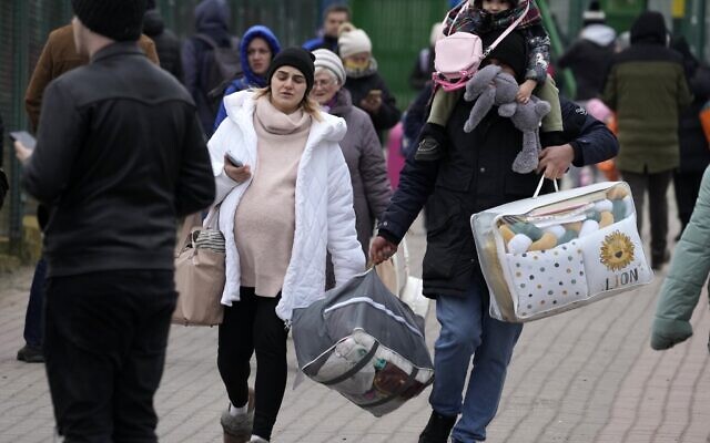 People fleeing the conflict from neighboring Ukraine arrive at the border crossing in Medyka, southeastern Poland, on Friday, February 25, 2022. (AP Photo/Czarek Sokolowski) People fleeing the conflict from neighboring Ukraine arrive at the border crossing in Medyka, southeastern Poland, on Friday, February 25, 2022. (AP Photo/Czarek Sokolowski)