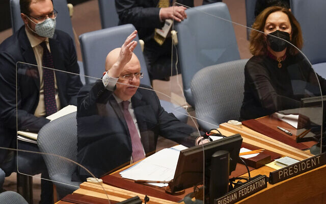Vasily Nebenzya, Russian ambassador to the United Nations, participates in a vote during a Security Council meeting at United Nations headquarters, Friday, Feb. 25, 2022. (AP Photo/Seth Wenig)