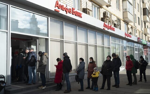People stand in line to withdraw money from an ATM of Alfa Bank in Moscow, Russia, Feb. 27, 2022 (AP Photo/Victor Berzkin)