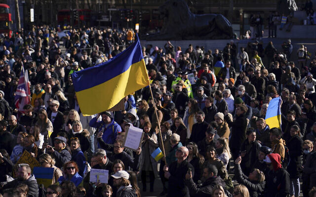 Ukrainian flags wave in Trafalgar Square as people descend to attend a protest, in London, on Sunday, February 27, 2022.  (AP Photo/Alberto Pezzali)