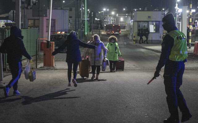Ukrainian family reunites at the Medyka border crossing in Poland on Sunday, Feb. 27, 2022. (Visar Kryeziu/AP)