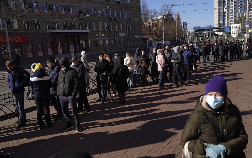 People wait in a queue outside a supermarket in central Kyiv, Ukraine, Feb. 28, 2022  (AP Photo/Emilio Morenatti)