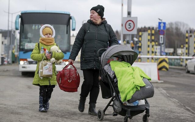 Refugees fleeing conflict in Ukraine arrive at the Medyka border crossing in Poland, Feb. 28, 2022. (Visar Kryeziu/AP)