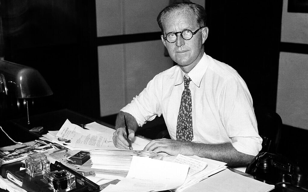 Joseph P. Kennedy, then chairman of the Securities and Exchange Commission is shown at work in his shirt sleeves during Washington's heat wave on July 16, 1934. (AP Photo)