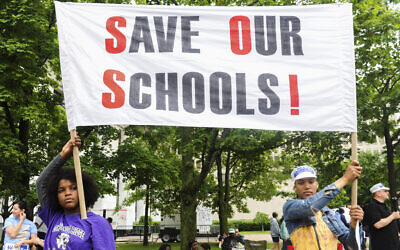 In this June 8, 2013, photo, students of the East Ramapo School District hold a sign during the One Voice United Rally in Albany, NY. (AP Photo/Shannon DeCelle, File)