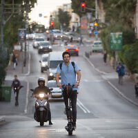 An illustrative photo of a person riding an electric scooter in Tel Aviv, November 27, 2019. (Miriam Alster/FLASH90)
