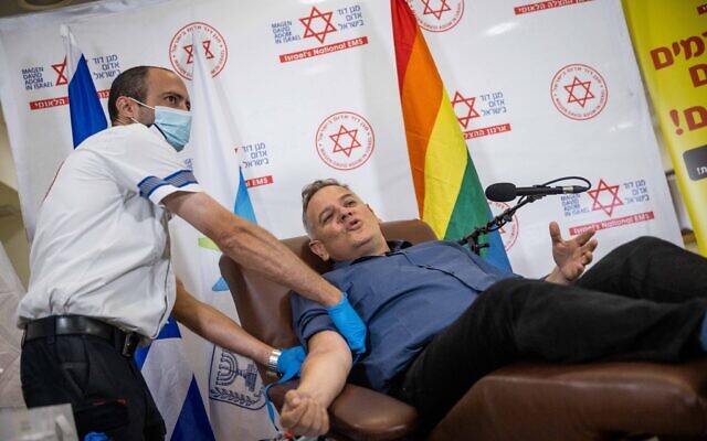 Minister of Health Nitzan Horowitz donates blood at a Magen David Adom blood donation center in Jerusalem, on October 25, 2021. (Yonatan Sindel/Flash90)