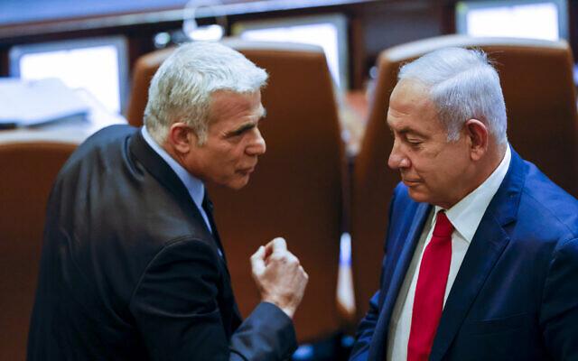 Foreign Minister Yair Lapid (left) with opposition leader Benjamin Netanyahu at a Knesset session in memory of Israel's first prime minister David Ben-Gurion, on November 8, 2021. (Olivier Fitoussi/Flash90)