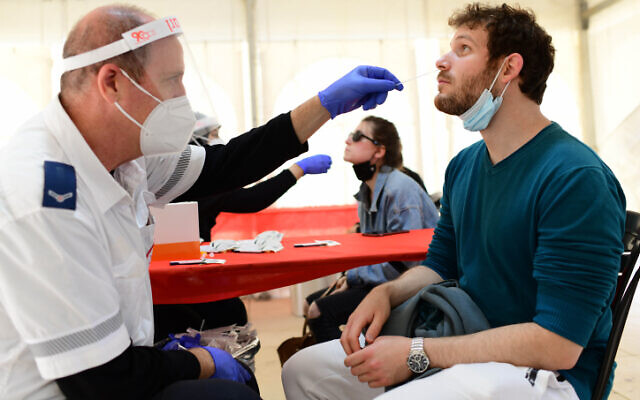 People get tested for COVID-19 at a testing center at Habima square in Tel Aviv on January 4, 2022. (Tomer Neuberg/Flash90)