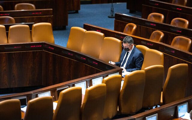 Justice Minister Gideon Sa'ar sits in the plenum hall of the Knesset, on February 16, 2022. (Olivier Fitoussi/Flash90)