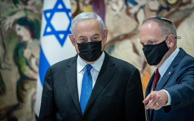 Opposition leader and former prime minister Benjamin Netanyahu (L) speaks William Daroff, CEO of the Conference of Presidents of Major American Jewish Organizations, at the Knesset in Jerusalem, February 22, 2022. (Yonatan Sindel/Flash90)