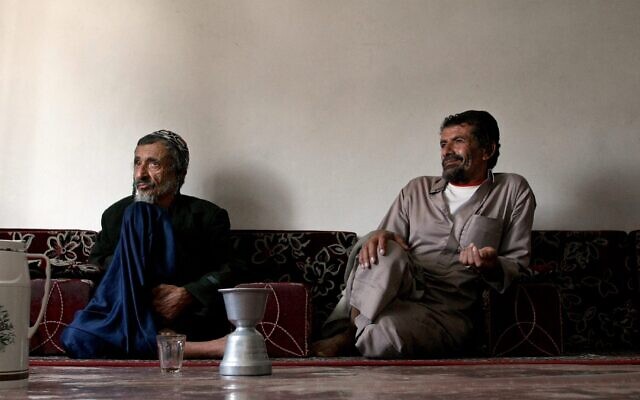 Yemeni Rabbi Youssef Moussa, left, and his brother Salem sit in an apartment in Sanaa, Yemen, Nov. 10, 2009, after fleeing a conflict in the northern part of the country. (Marwan Naamani/AFP via Getty Images/JTA)
