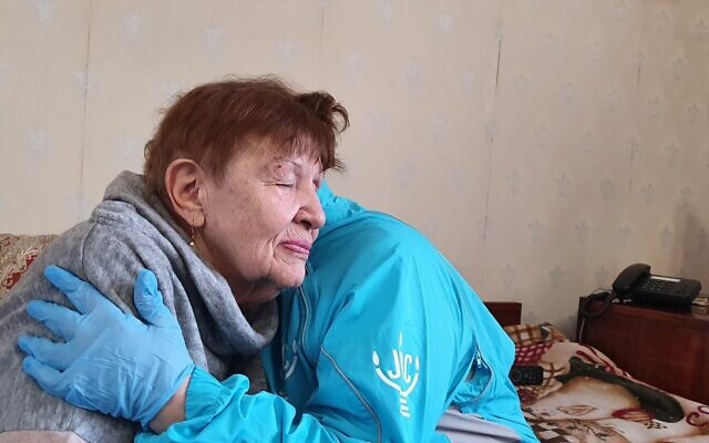 A Hesed social worker hugs a client in Odesa on Monday, February 28, 2022. (JDC)