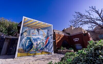 The pop surrealist art of Dutch artist Leon Keer, whose distorted teapot mural now decorates a wall in Old Jaffa, dedicated on February 24, 2022 (Courtesy Meijler Art)