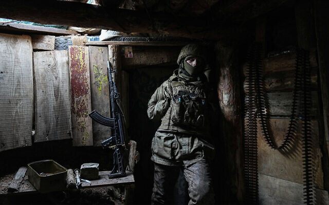 A Ukrainian serviceman stands in a shelter on a position at the line of separation between Ukraine-held territory and rebel-held territory near Zolote, Ukraine, on February 19, 2022. (AP/Evgeniy Maloletka)
