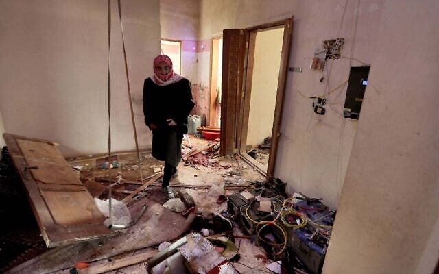 A man walks through the house where Islamic State leader Abu Ibrahim al-Hashimi al-Qurayshi was killed by US forces the night before, February 3, 2022. (Aaref Watad/AFP)