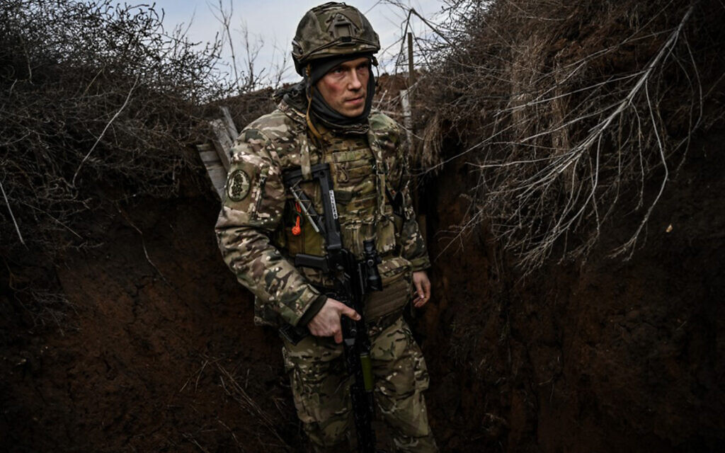 Ukrainian troops patrol the frontline outside the town of Novoluhanske, eastern Ukraine, on February 19, 2022. (Aris Messinis/AFP)
