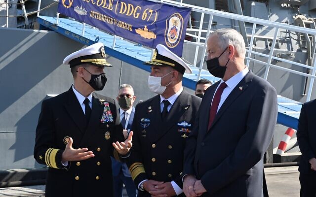 Defense Minister Benny Gantz, right, along with Israeli Navy chief David Salama, center, speak with the head of the US Navy's 5th Fleet, Admiral Brad Cooper, in front of the USS Cole in Bahrain on February 3, 2022. (Ariel Hermoni/Defense Ministry)
