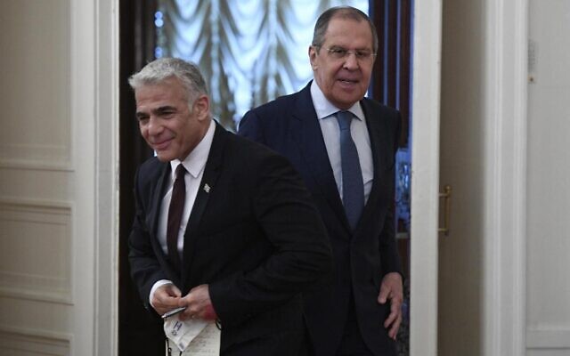 Russian Foreign Minister Sergey Lavrov, right, welcomes Foreign Minister Yair Lapid, prior to their talks in Moscow, Russia, Thursday, Sept. 9, 2021. (Alexander Nemenov/Pool Photo via AP)