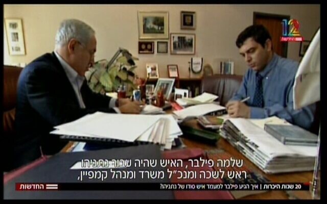 Then-prime minister Benjamin Netanyahu (left) sitting with then-PMO chief of staff Shlomo Filber, on February 21, 2018 (Screenshot/Channel 12 news)