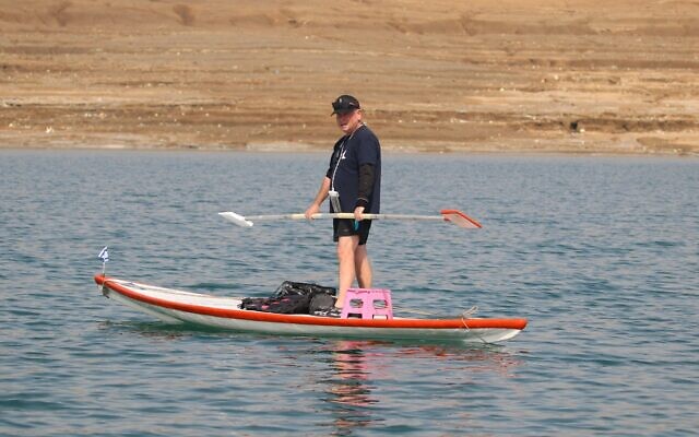 Benny 'Pinky' Hod sails his hasake board from where the Jordan River enters the Dead Sea to Kalia Beach, February 18, 2022. (Malka Nihom)