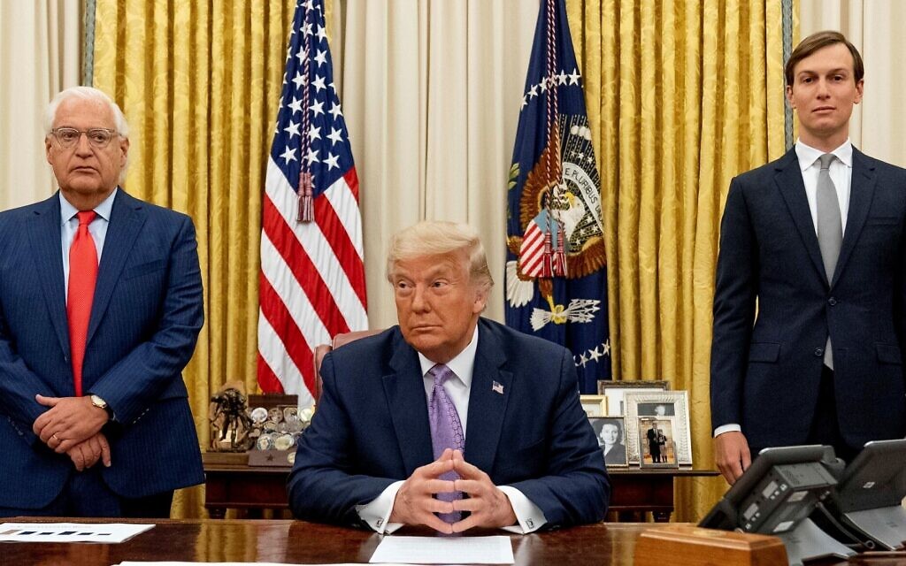 Then-US president Donald Trump, center, is flanked by then-ambassador to Israel David Friedman, left, and then-senior adviser Jared Kushner in the Oval Office on August 12, 2020. (AP/Andrew Harnik)