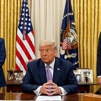 Then-US president Donald Trump, center, is flanked by then-ambassador to Israel David Friedman, left, and then-senior adviser Jared Kushner in the Oval Office on August 12, 2020. (AP/Andrew Harnik)