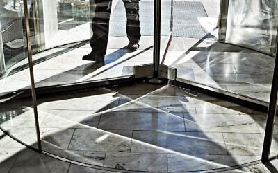 A person walking through a revolving door. Illustrative.(AnkiHoglund via iStock by Getty Images)