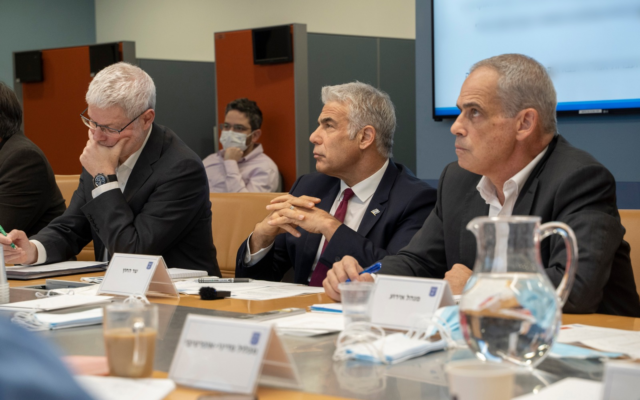 Foreign Minister Yair Lapid (C) at a situational assessment on February 27, 2022 (Yossi Pines/GPO)