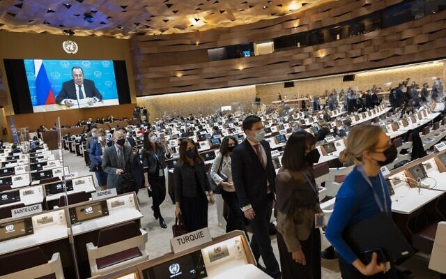 Ambassadors and diplomats leave while Russia's Foreign Minister Sergei Lavrov (on screen) speaks via a pre-recorded video message at the 49th session of the UN Human Rights Council at the European headquarters of the United Nations in Geneva, Switzerland, March 1, 2022. (SALVATORE DI NOLFI / POOL / AFP)