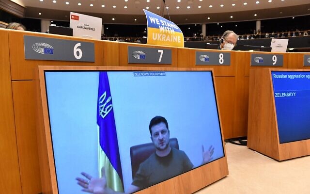 Ukrainian President Volodymyr Zelensky appears on a screen as he speaks in a video conference during a special plenary session of the European Parliament focused on the Russian invasion of Ukraine at the EU headquarters in Brussels, on March 01, 2022. (JOHN THYS / AFP)
