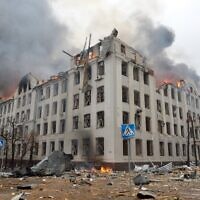Firefighters work to contain a fire at the Economy Department building of Karazin Kharkiv National University, allegedly hit during recent shelling by Russia, on March 2, 2022. (Sergey BOBOK / AFP)