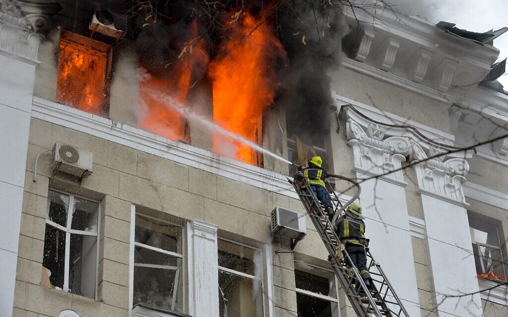 Firefighters work to contain a fire in the complex of buildings housing the Kharkiv regional SBU security service and the regional police, allegedly hit during recent shelling by Russia, in Kharkiv on March 2, 2022. (Sergey BOBOK / AFP)