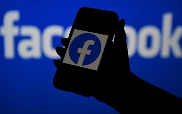 In this illustrative file photo, a smartphone screen displays the logo of Facebook on a Facebook website background, on April 7, 2021, in Arlington, Virginia. (Olivier Douliery/AFP)