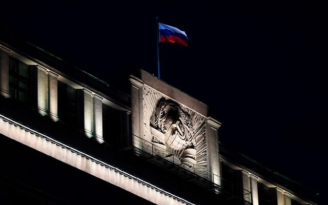 The Russian national tricolor flag flutters on top of the building of the State Duma, the lower chamber of Russia's parliament, in central Moscow in the evening of March 3, 2022. (AFP)