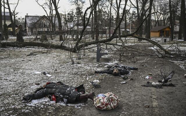 Bodies of civilians lie in a park in Irpin, north of Kyiv, on March 10, 2022. (Aris Messinis/AFP)