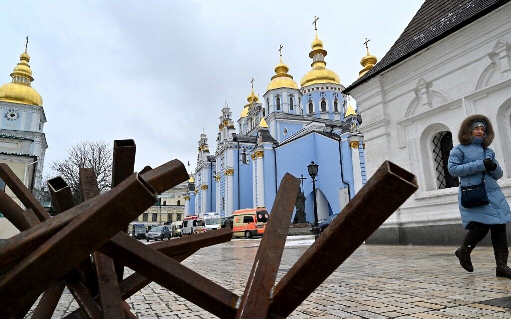 A woman leaves Kyiv's Mykhailo Golden-Domes Cathedral after a memorial service for Ukrainians who died in the Russian invasion, held by Epiphanius, primate of the Orthodox Church of Ukraine, on March 13, 2022. (Sergei Supinsky/AFP)