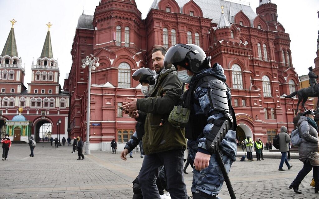 Russian police officers detain a man during a protest against Russia's invasion of Ukraine, in Manezhnaya Square in central Moscow on March 13, 2022. (AFP)