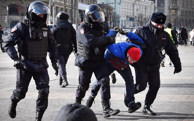 Russian police officers detain a man during a protest against Russia's invasion of Ukraine, in Manezhnaya square in central Moscow on March 13, 2022. (AFP)
