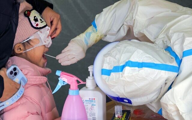 A child undergoes a nucleic acid test for the COVID-19 coronavirus in Yantai, in China's eastern Shandong province, March 14, 2022. (AFP photo / China OUT)
