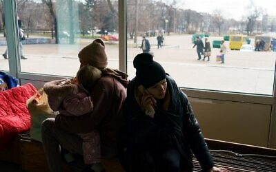 Evacuees from Mariupol wait at the Zaporizhzhya State Circus for transportation to other locations in the city of Zaporizhzhia on March 16, 2022. (Emre CAYLAK / AFP)