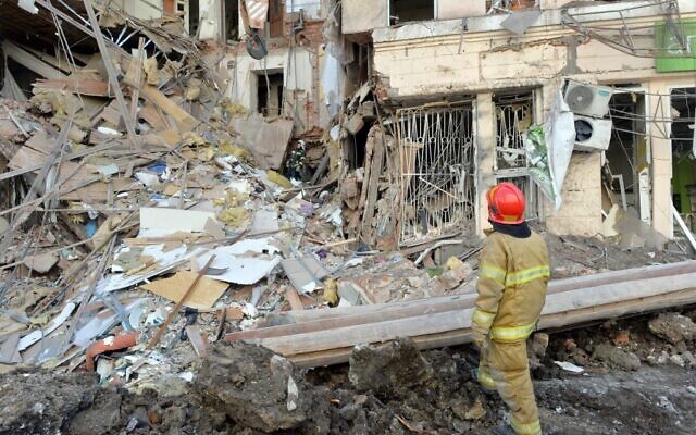 Rescuers remove debris from a building damaged by shelling in central Kharkiv on March 16, 2022, amid the ongoing Russia's invasion of Ukraine. (Sergey Bobok/AFP)