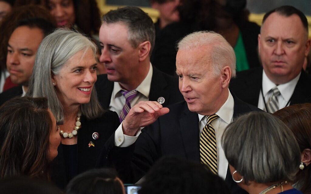 US President Joe Biden talks with guests during an event celebrating the reauthorization of the Violence Against Women Act, in the East Room of the White House in Washington, DC, on March 16, 2022. (Nicholas Kamm / AFP)